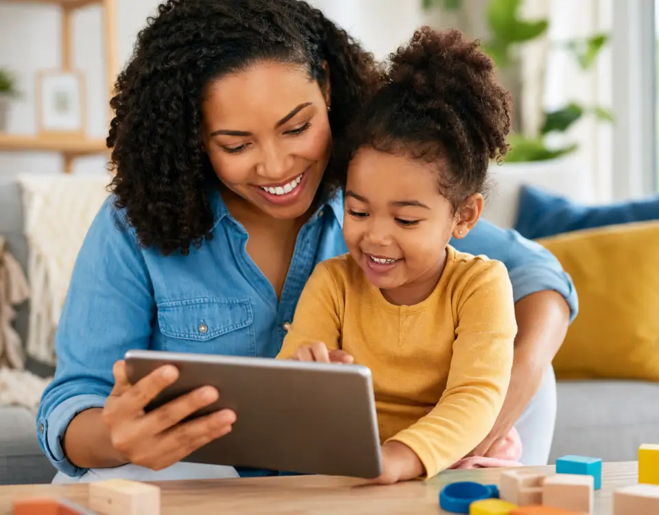 Mother and daughter using educational app on tablet